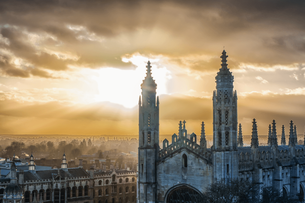 spires in Cambridge set over the sun